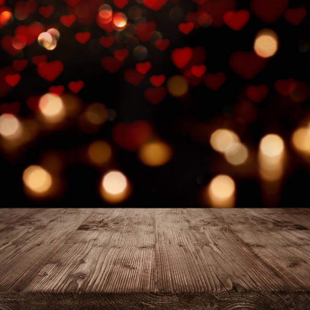 Background for love greetings Background with hearts and bokeh in front of a wooden table for loving greetings groyne photos stock pictures, royalty-free photos & images