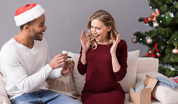 istock Loving delighted man presenting his girlfriend with a ring 625472892