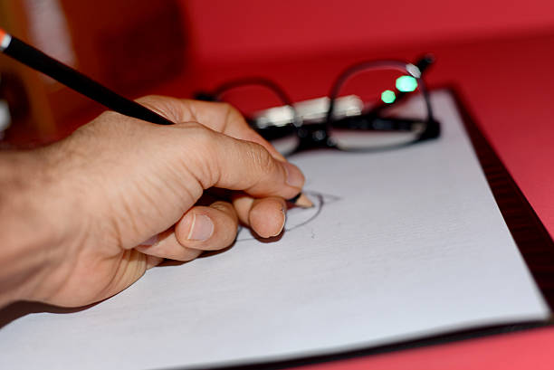 istock Unrecognizable person writing on a piece of paper 625483784