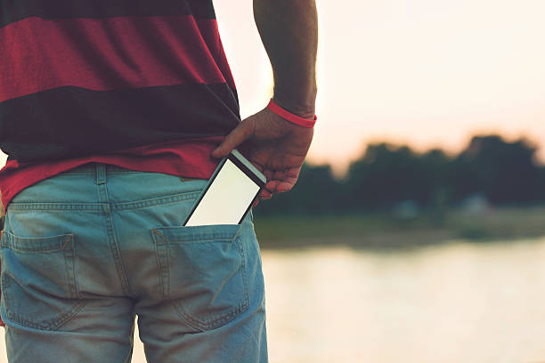 Man using cellphone outdoors. stock photo