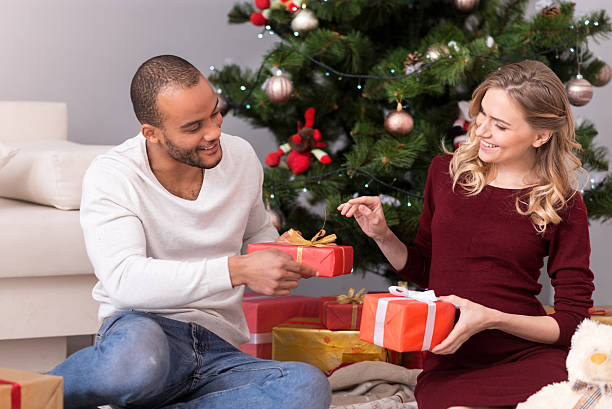 istock Positive delighted couple exchanging their presents 625484474