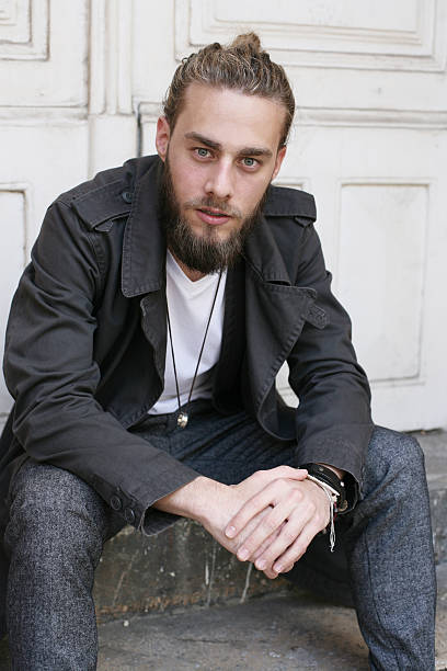 istock Young man sitting on stairs. 625492938