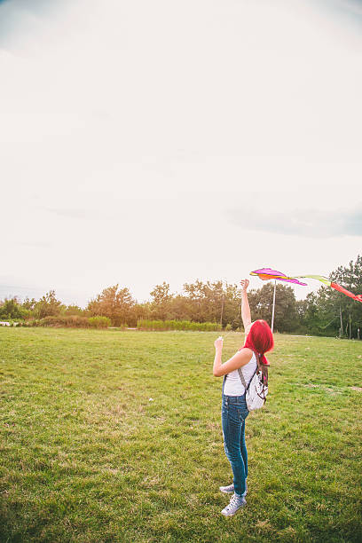 istock Young woman flying a kite 625498944