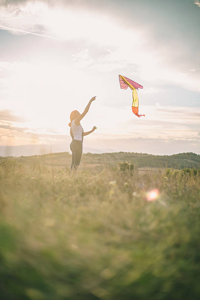 istock Young woman flying a kite 625504984