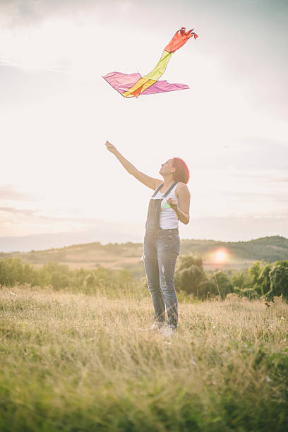 istock Young woman flying a kite 625505230