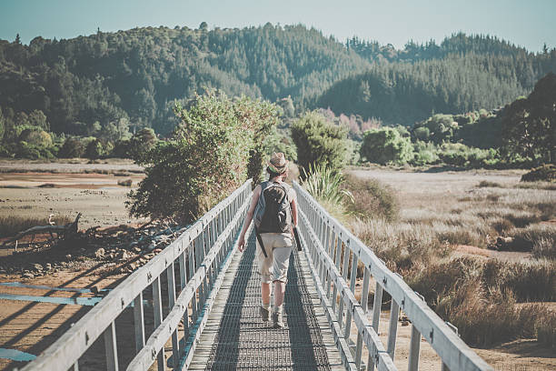 woman walking abel tasman coast track, new zealand south island - abel tasman national park imagens e fotografias de stock