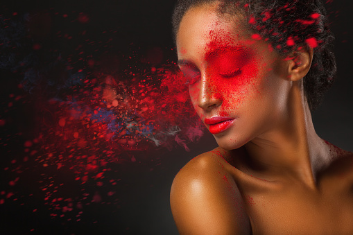 Premium Photo  A woman with black face paint and red dots