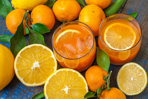 istock Useful fresh juice, oranges, tangerines, lemons, ice, leaves. 625508990