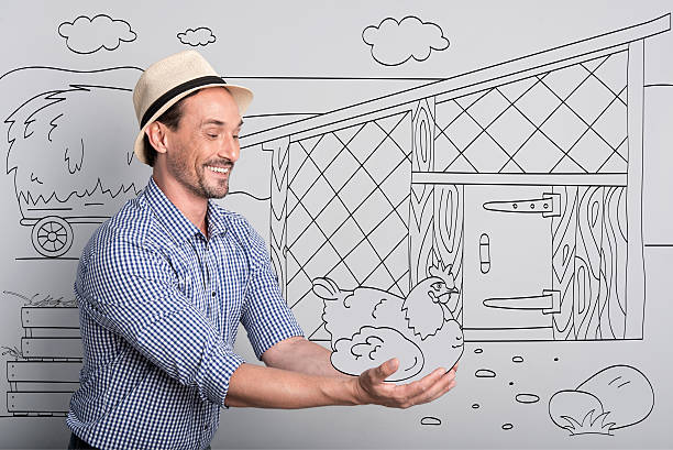 istock Smiling handsome farmer holding chicken. 625509968