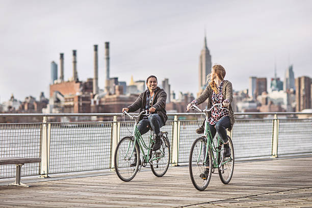 istock Young couple riding bicycles on promenade 625523954