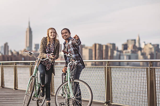 istock Young couple with bicycles standing on promenade 625524278