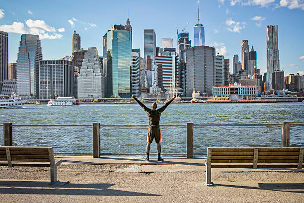 istock Excited young man on promenade with Manhattan skyline 625525860