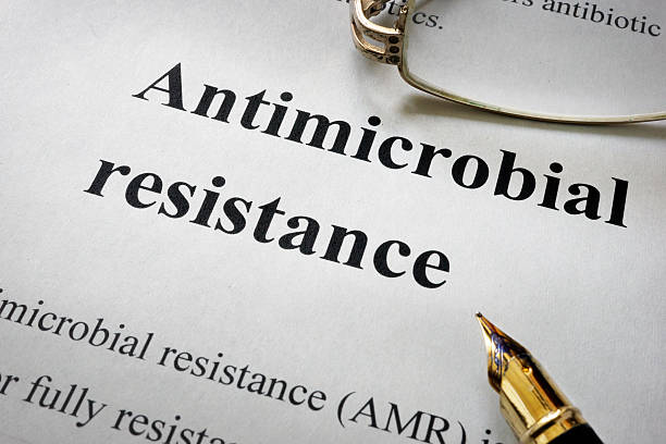 Paper with words antimicrobial resistance AMR and glasses.