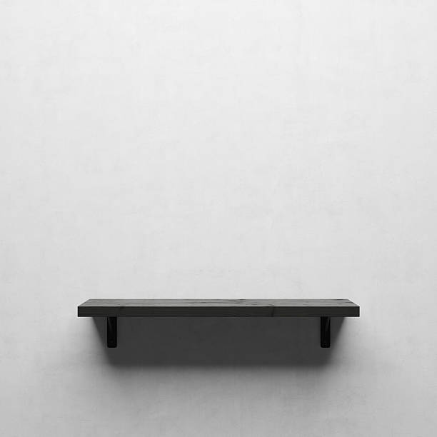 istock Black wooden shelf on white wall 625529636