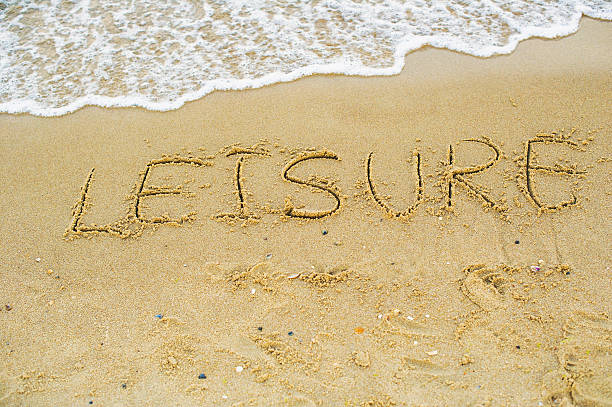 istock Word leisure written on beach sand 625529808