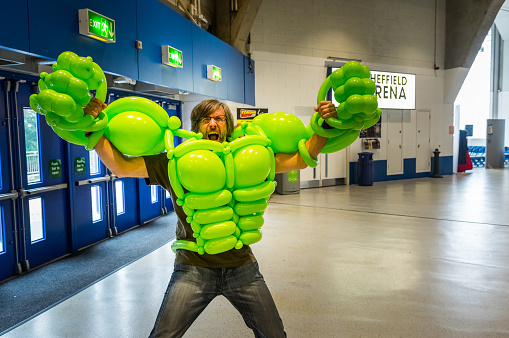 Sheffield, United Kingdom - June 12, 2016: Cosplayer posing in a balloon costume of the 'Incredible Hulk' from Marvel at the Yorkshire Cosplay Convention at Sheffield Arena