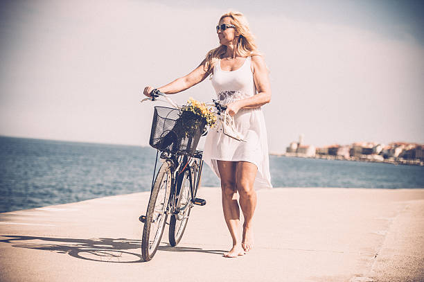 istock Mature woman riding bicycle 625552374