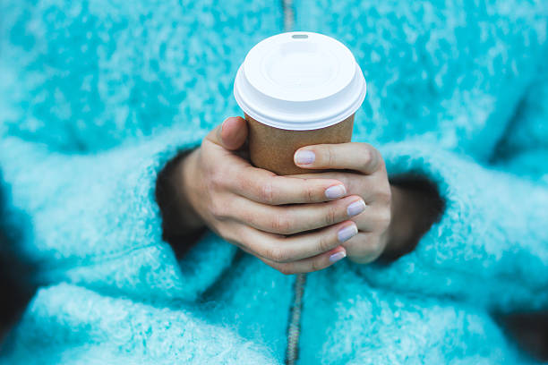 istock Girl's hands holding a cup of warming beverage 625587472