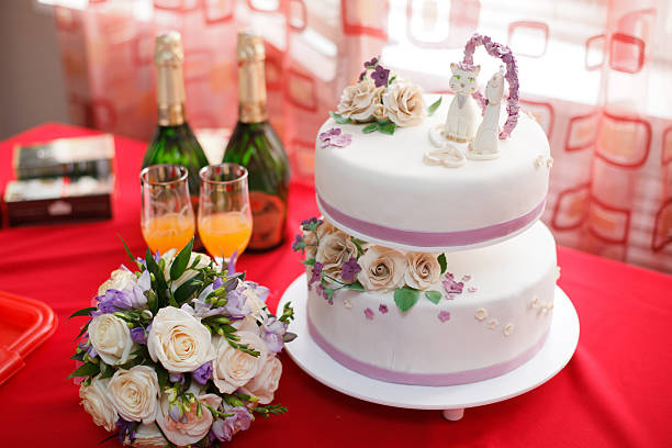 istock Wedding mastic cake decorated with flowers and cat figures, closeup 625592976