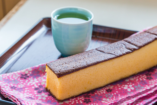 Castella - traditional Japanese sponge cake and hot tea on the table
