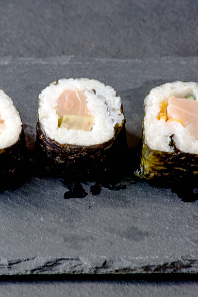 istock Pieces of sushi on a black stone 625596148