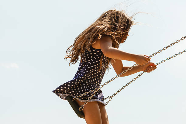 istock Girl swinging on swing-set. 625596294