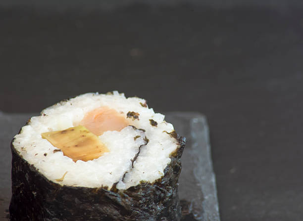 istock Pieces of sushi on a black stone 625599606