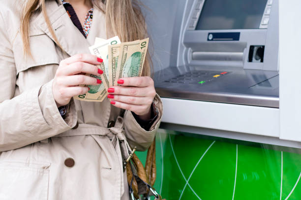 istock Woman taking cash from ATM 625608222