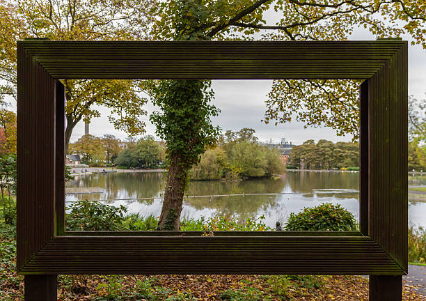istock View through large hollow picture frame of trees and pond 625624820