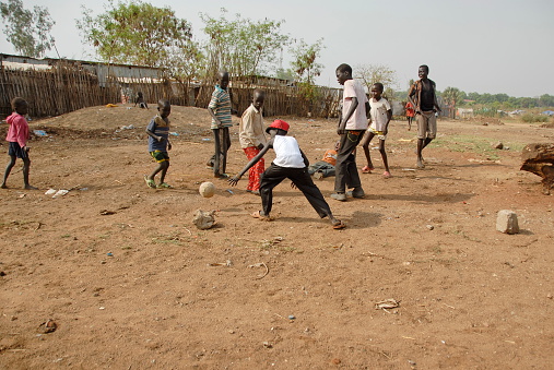 Juba, South Sudan - FEBRUARY 26, 2012: Unidentified kids play football on a street of Juba on February 26, 2012 in Juba, South Sudan.