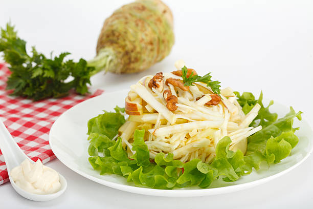Winter salad with celery and apples Winter salad with celery and apples on white plate Celeriac stock pictures, royalty-free photos & images