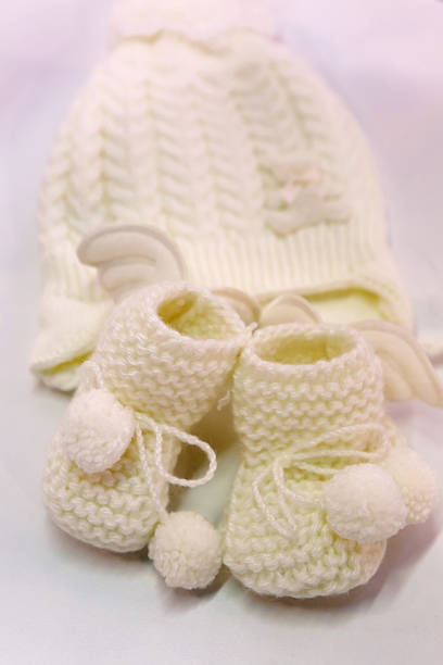 istock white knitted baby booties and hat 625626848