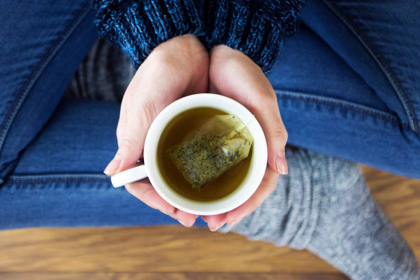 Woman having a cup of tea Tea, Drink, Healthy, Cup, Hot, Teacup, Sweet, Freshness, Culture, Warm, Relax cup of tea hands stock pictures, royalty-free photos & images