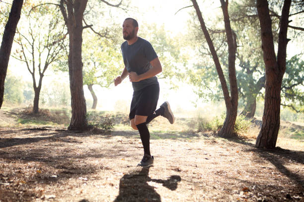istock Young man running at park 625642960