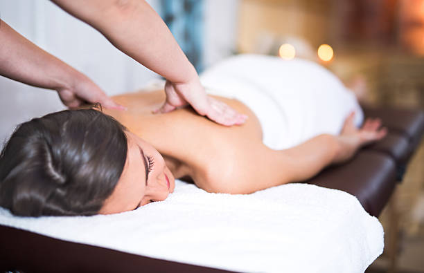 istock Young smiling brunette woman enjoying a back massage 625648552