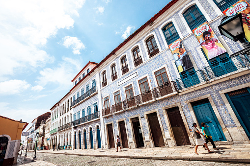 Sao Luis, Brazil - February 4, 2013: Only a few people walking around in the  streets of old town district on a hot afternoon.