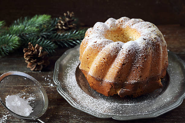 New Year dessert: homemad Kouglof Christmas dessert: homemade Kouglof, icing sugar dressing black german shepherd dog or alsatian wolf dog stock pictures, royalty-free photos & images