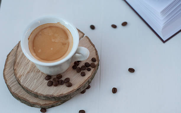 istock White cup of coffee on the white wooden background 625653084