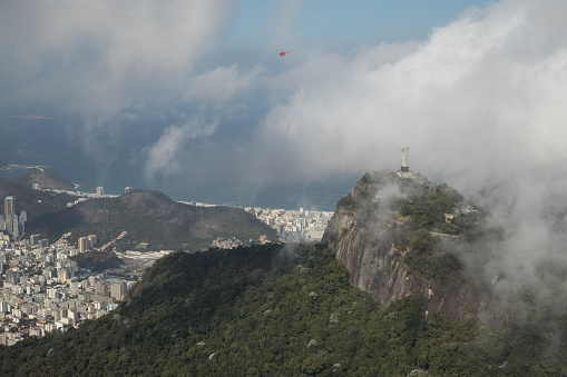 Aerial view from a helicopter flying over Christ The Redeemer, statue in Rio de Janeiro, Brazil