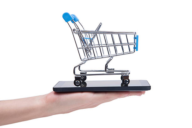 istock Hand Holding Mobile Phone And Small Shopping Cart 625660924