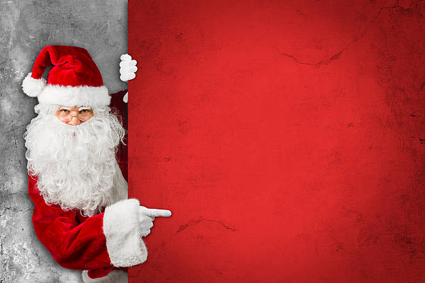 istock santa claus looking behind empty concrete billboard sign wall 625661006