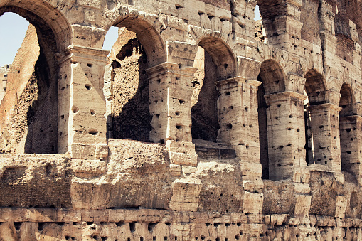 Close up view of Colosseum in Rome. Monumental 3-tiered Roman amphitheater once used for gladiatorial games.