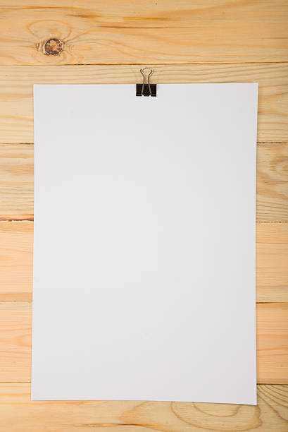 istock Black clip and White blank note paper hang on wood 625669768