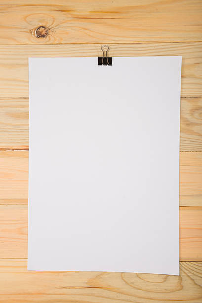 istock Black clip and White blank note paper hang on wood 625669790