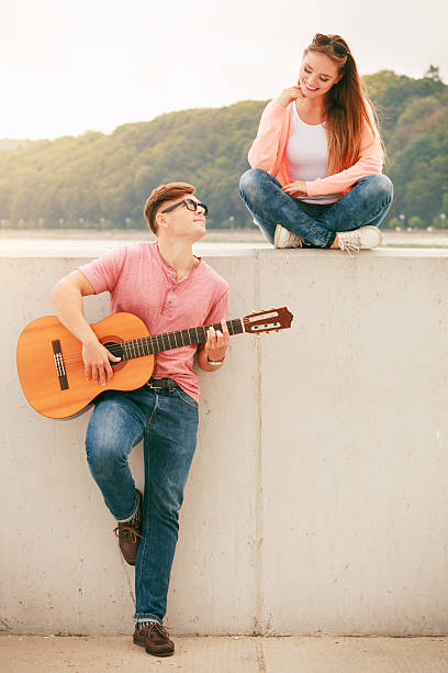 istock Happy couple with guitar outdoor 625670622