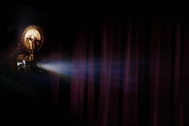 istock Old film projector with dark room background 625670752