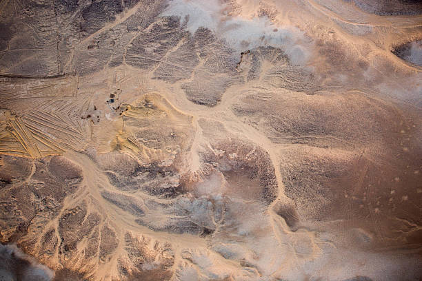 An aerial view of the sunrise highlighting the top edges of the desert's dunes near Luxor.