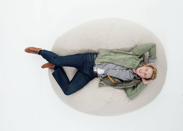 istock Above view of man lying on bean bag 625675366