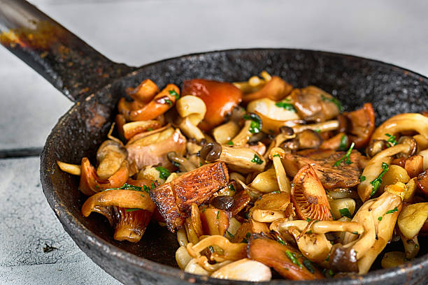 Sauteed wild mushrooms Sauteed wild mushrooms with garlic and parsley sauteed stock pictures, royalty-free photos & images
