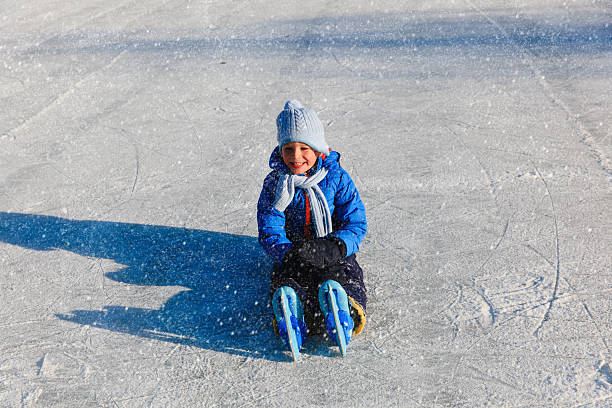 istock happy little boy learning to skate in winter 625681842